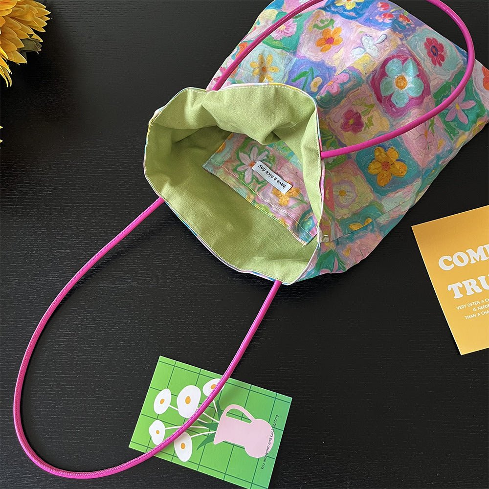 Floral cotton canvas tote bag with multi-flower pattern, lightweight durable design, fits phone, wallet and daily essentials.