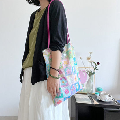 Floral cotton canvas tote bag with multi-flower pattern, lightweight durable design, fits phone, wallet and daily essentials.