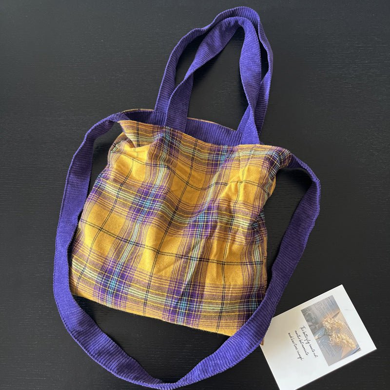 Purple corduroy tote bag with soft textured fabric, spacious interior, durable stitching, for daily use, commuting & travel.