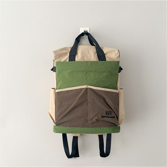 Green lightweight backpack, 350g, expandable, water-resistant, fits iPad, clothes, and daily commuting essentials.